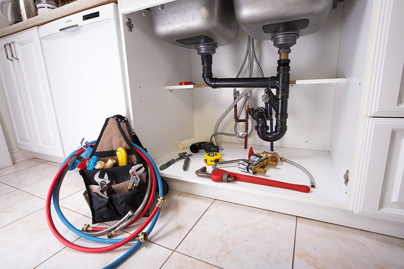 Image of the kitchen sink plumbing; emergency repair work completed by KPM.